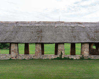 Built structure on field against sky