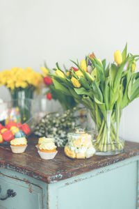 Close-up of sweet food and flowers on table