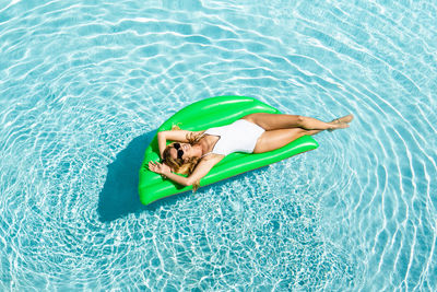 High angle view of baby lying in swimming pool