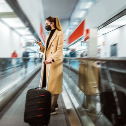 Young woman standing in train