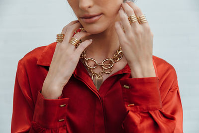 Low section of woman standing against red background