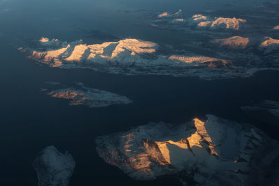 Aerial view of mountain range against sky during sunset