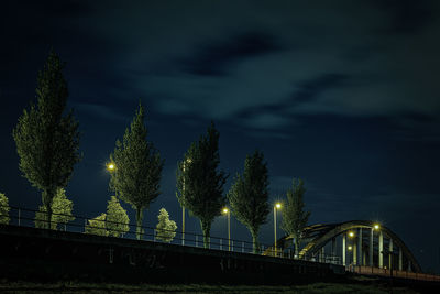 Illuminated bridge against sky at night