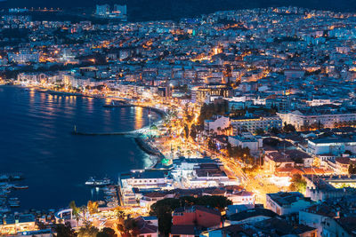 High angle view of illuminated buildings in city at night