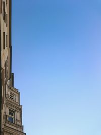 Buildings against clear blue sky