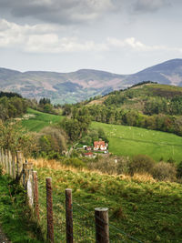 Scenic view of field and mountains against sky