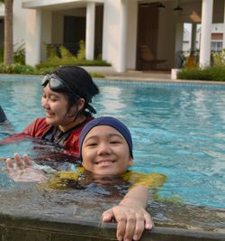 Portrait of a smiling young woman swimming pool