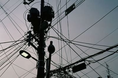 Low angle view of electricity pylon against sky