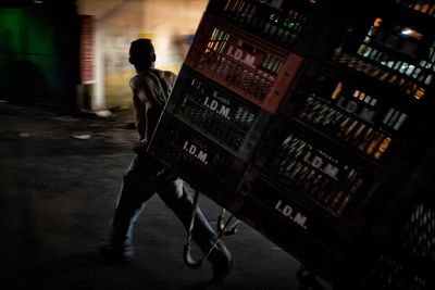 Man pulling plastic crates