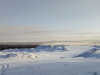 Scenic view of snow covered landscape against sky