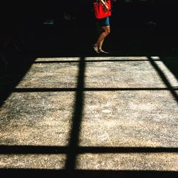 Low section of woman standing on tiled floor