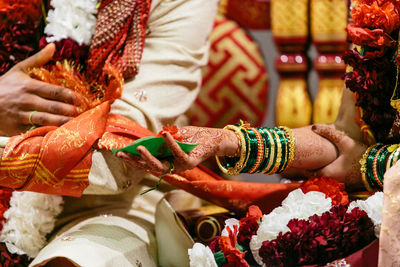 Midsection of newlywed couple during ceremony