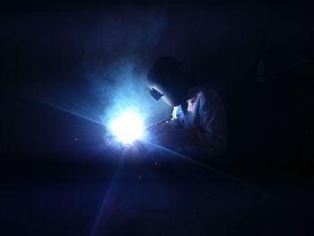 Male welder welding in factory