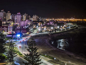 High angle view of illuminated city buildings at night