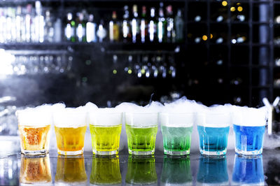 Glass of bottles on table