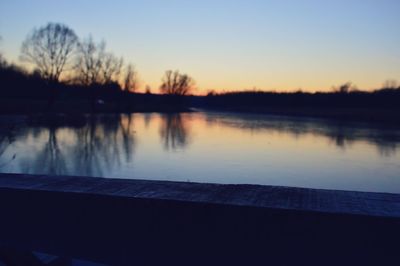 Scenic view of lake against sky at sunset