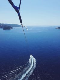 Rope attached to boat sailing in sea