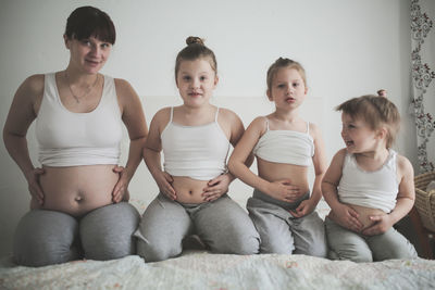 Pregnant mother with 3 daughters, a lifestyle in a real interior. the concept of a large family 