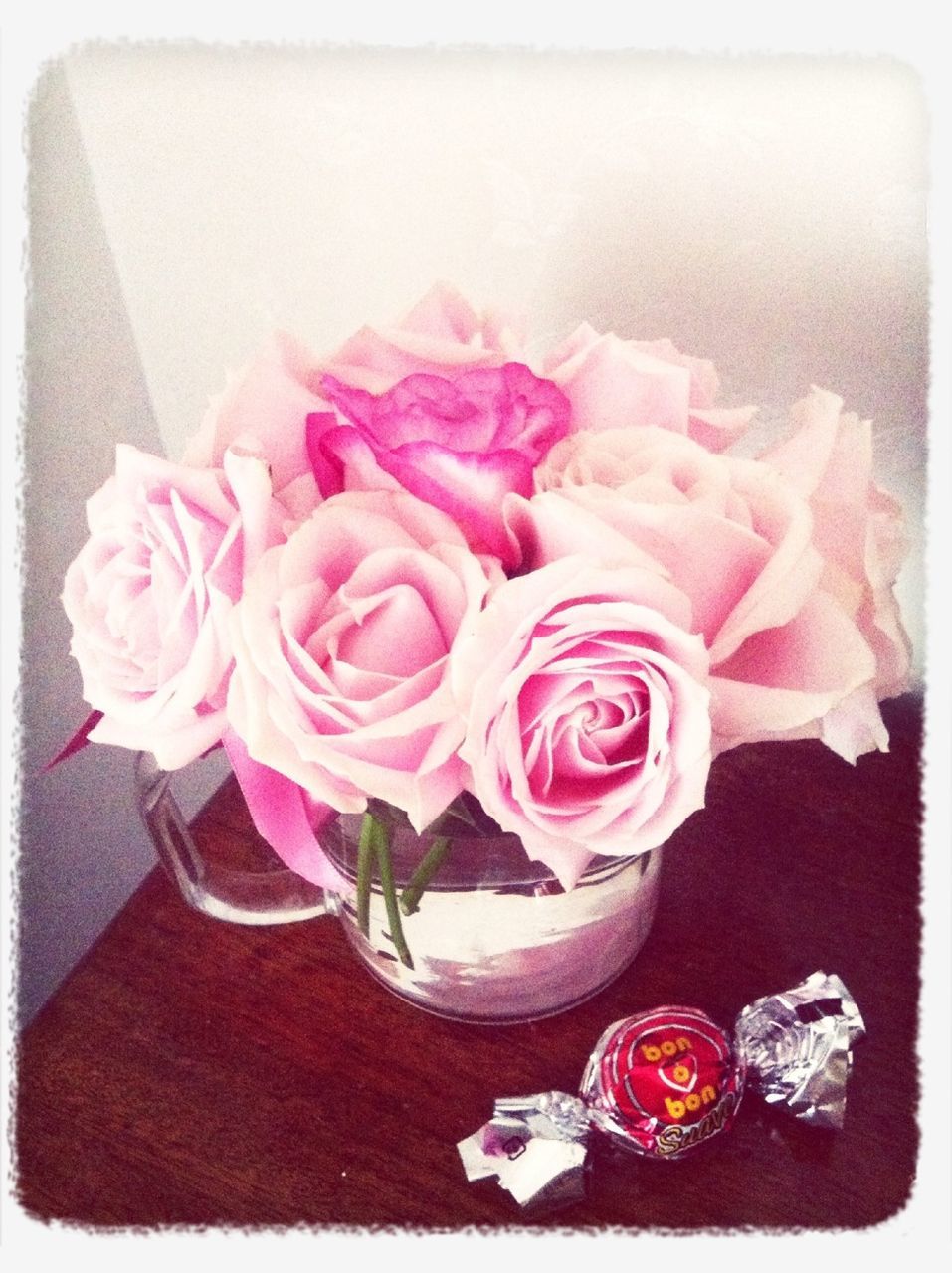 flower, transfer print, freshness, indoors, rose - flower, pink color, petal, fragility, auto post production filter, flower head, close-up, vase, table, still life, beauty in nature, pink, rose, no people, nature, bouquet