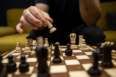 Full length of man playing on chess board