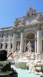 Statue of fountain in front of building