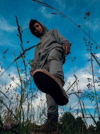 Low angle view of man standing against sky