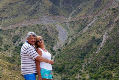 Portrait of couple standing on mountain