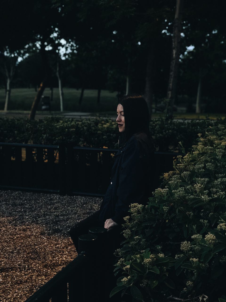 one person, plant, real people, tree, young adult, sitting, nature, three quarter length, leisure activity, side view, lifestyles, land, growth, young women, looking, young men, looking away, adult, women, outdoors, track, contemplation