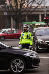 Full length portrait of man in city