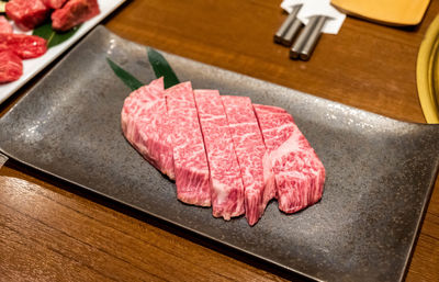 High angle view of hida beef meat on cutting board