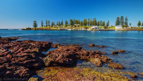 Scenic view of sea against clear blue sky