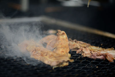 Close-up of meat on barbecue grill