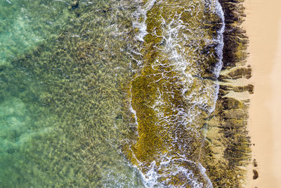 High angle view of water flowing through rocks