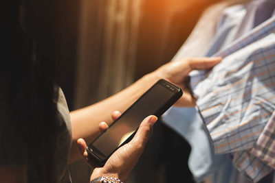 Midsection of man using mobile phone