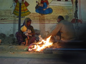 People sitting on bonfire