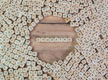 Directly above shot of shopping text amidst wooden cubes