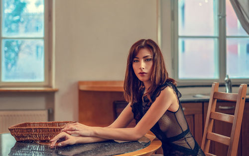 Portrait of young woman sitting outdoors