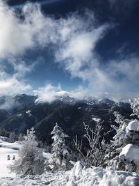 Scenic view of snow covered mountains against sky