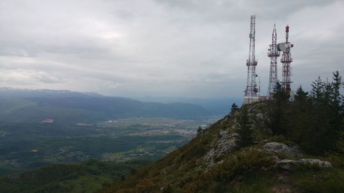 Aerial view of communications tower and mountains against sky