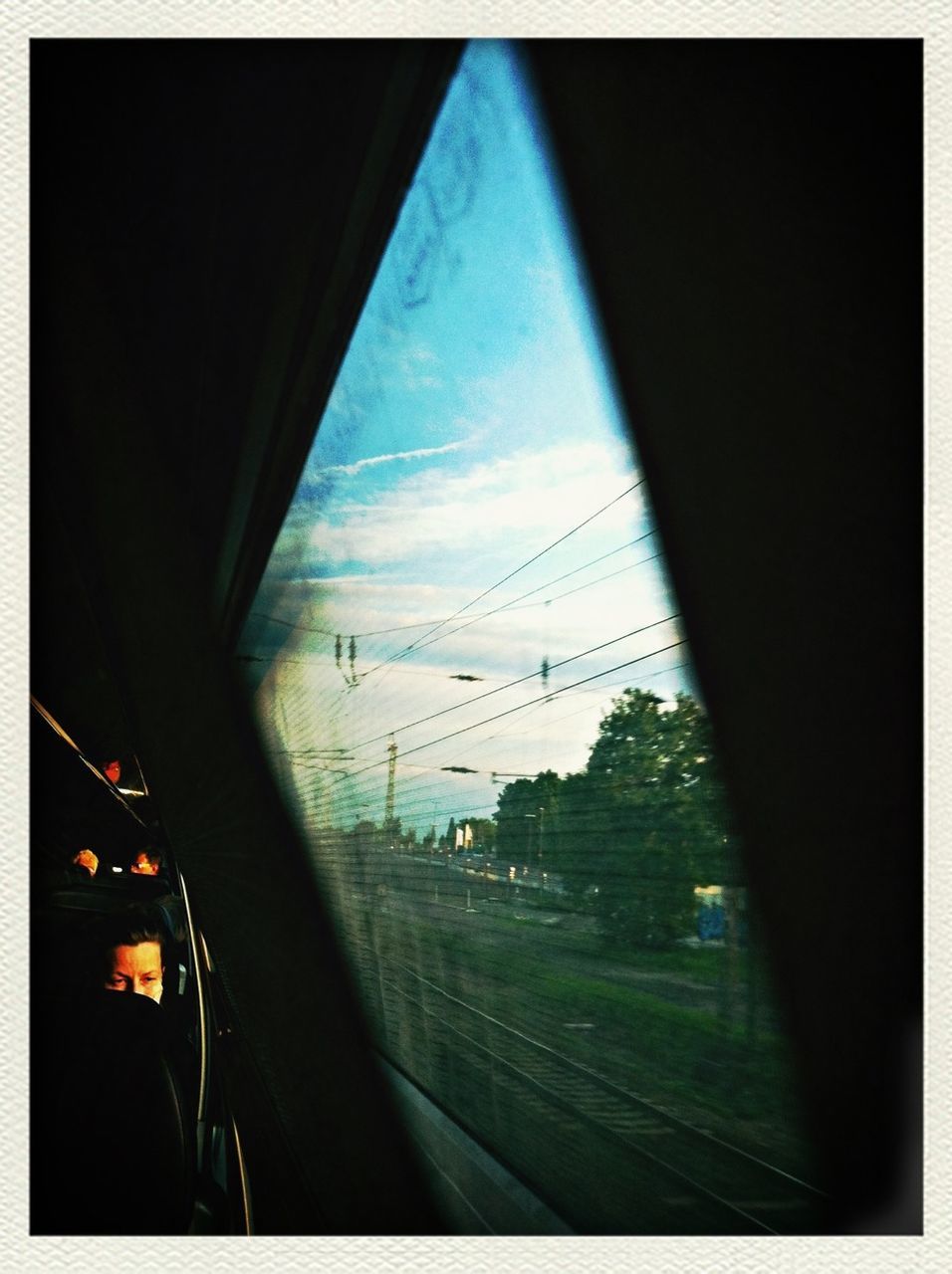 transportation, mode of transport, vehicle interior, glass - material, sky, land vehicle, transparent, car, transfer print, public transportation, window, on the move, railroad track, road, auto post production filter, travel, windshield, train - vehicle, indoors, power line