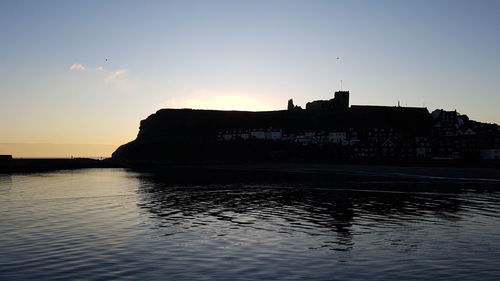 Silhouette of buildings at seaside