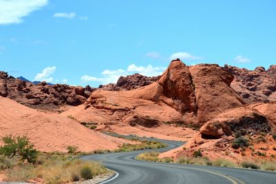 Road in desert against blue sky