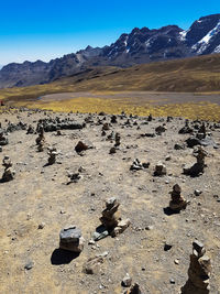 Scenic view of landscape and mountains against blue sky