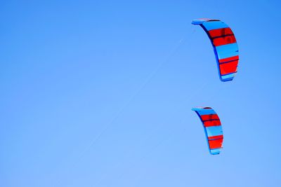 Low angle view of flag against clear blue sky