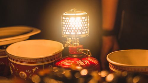 Close-up of illuminated tea light candles on table