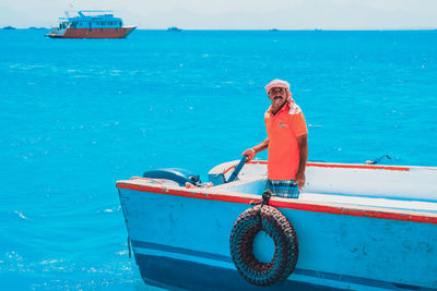 Woman standing on boat in sea