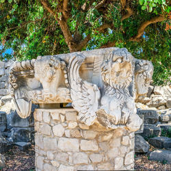 Statue against stone wall in park