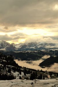 Scenic view of snowcapped mountains against sky during winter