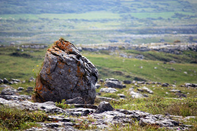 Rocks on land against mountains