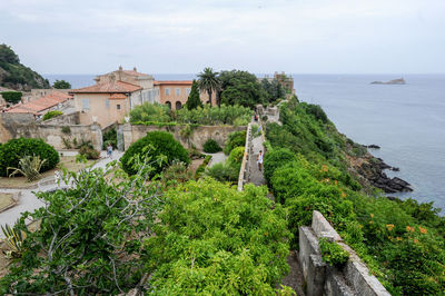 Panoramic view of historic building by sea against sky